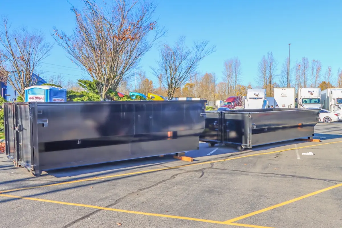 Professional dumpster rental service with roll-off container on residential driveway in Rosedale